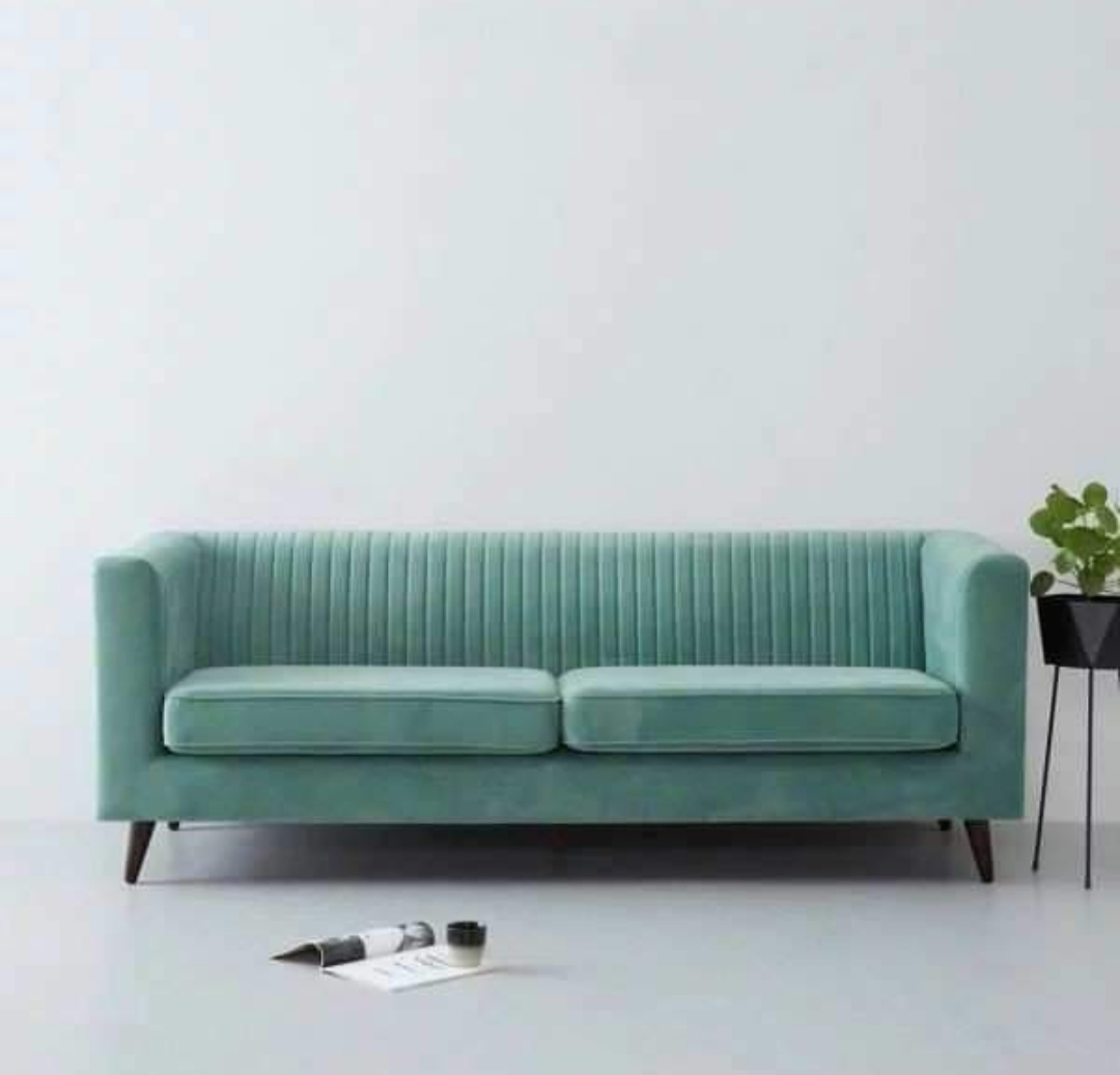 Elegant mint green velvet 3-seater sofa in a minimal living room setup