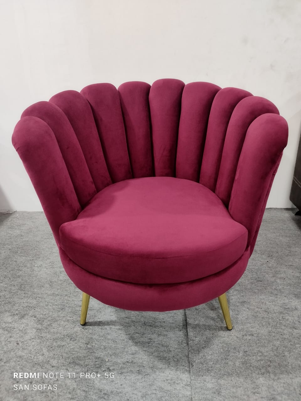 Luxurious velvet accent chair in deep maroon with scalloped shell back design and gold metal legs