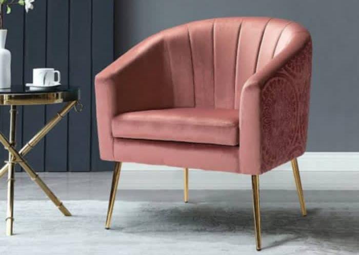 Modern blush pink velvet accent chair with vertical stitching and gold metal legs for luxury living room